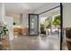 Spacious open-concept living space with kitchen island, and sliding door access to patio at 11331 E Cochise Dr, Scottsdale, AZ 85259