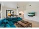 Spacious living room with high ceilings, blue sectional, and a view to the outdoors at 11331 E Cochise Dr, Scottsdale, AZ 85259