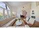 Bright living room features a fireplace, vaulted ceilings, and large windows at 11331 E Cochise Dr, Scottsdale, AZ 85259