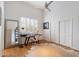 Bright office space featuring shuttered windows, hardwood floors, and a hide rug at 11331 E Cochise Dr, Scottsdale, AZ 85259