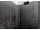 Modern shower showcasing dark large-format tile and sleek hardware, offering a luxurious and stylish bathing experience at 11331 E Cochise Dr, Scottsdale, AZ 85259