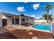 Backyard with a sparkling pool, covered patio, and meticulously maintained mulch at 1203 E Bishop Dr, Tempe, AZ 85282