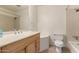 Traditional bathroom features a wood vanity, large mirror, and a combined tub and shower at 1203 E Bishop Dr, Tempe, AZ 85282