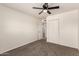 Cozy bedroom with carpet, ceiling fan, closet, and an open doorway to another room at 1203 E Bishop Dr, Tempe, AZ 85282