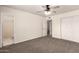 Bedroom with carpet, ceiling fan, closet, view to bathroom and a view to another room at 1203 E Bishop Dr, Tempe, AZ 85282