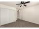 Bedroom featuring neutral walls, carpet, and double sliding door closet at 1203 E Bishop Dr, Tempe, AZ 85282