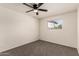 Bright bedroom with a ceiling fan, neutral carpet, and a window providing natural light at 1203 E Bishop Dr, Tempe, AZ 85282