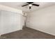 This bedroom includes carpet, a ceiling fan, closet, and an open doorway to another room at 1203 E Bishop Dr, Tempe, AZ 85282