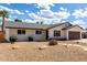 Charming single-story home with a two-car garage and desert landscaping on a sunny day at 1203 E Bishop Dr, Tempe, AZ 85282