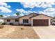 Charming single-story home with a two-car garage and desert landscaping on a sunny day at 1203 E Bishop Dr, Tempe, AZ 85282