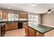 Open kitchen featuring wood cabinets, dark countertops and black appliances with sliding glass door to the backyard at 1203 E Bishop Dr, Tempe, AZ 85282