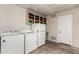 Practical laundry room with a washer, dryer, refrigerator, and ample storage space at 1203 E Bishop Dr, Tempe, AZ 85282