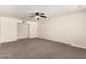 Spacious living room featuring neutral carpet and a ceiling fan at 1203 E Bishop Dr, Tempe, AZ 85282