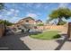 Backyard features a pool, gravel landscaping, and a patch of artificial turf at 12513 W Dreyfus Dr, El Mirage, AZ 85335