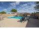 Inviting backyard pool with patio seating and sunshade for relaxation at 12513 W Dreyfus Dr, El Mirage, AZ 85335