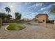 Backyard pool area with desert landscaping and an outdoor grill, perfect for relaxing at 12513 W Dreyfus Dr, El Mirage, AZ 85335