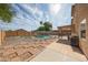 A backyard pool with a patio and desert landscaping is perfect for enjoying sunny days at 12513 W Dreyfus Dr, El Mirage, AZ 85335