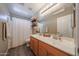 Well-lit bathroom featuring double sinks and shower/tub combo at 12513 W Dreyfus Dr, El Mirage, AZ 85335