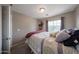 Bedroom with a plush blanket on a metal frame bed with neutral walls and grey carpet at 12513 W Dreyfus Dr, El Mirage, AZ 85335