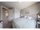 Comfortable bedroom featuring closet, bedside table, and neutral decor at 12513 W Dreyfus Dr, El Mirage, AZ 85335