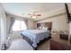 Serene bedroom with natural light, ceiling fan, and comfortable bedding at 12513 W Dreyfus Dr, El Mirage, AZ 85335