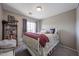 Comfortable bedroom with a metal bed frame and grey carpet with an open bookcase at the back at 12513 W Dreyfus Dr, El Mirage, AZ 85335