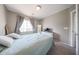 Neutral bedroom featuring soft carpet, natural lighting, and a view of the outside from a big window at 12513 W Dreyfus Dr, El Mirage, AZ 85335