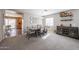 Formal dining area with stylish furnishings and a view into the kitchen at 12513 W Dreyfus Dr, El Mirage, AZ 85335