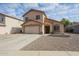 Two-story home featuring a two-car garage and low maintenance desert landscaping at 12513 W Dreyfus Dr, El Mirage, AZ 85335