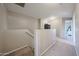 Upstairs hallway featuring carpet, neutral paint, and access to other rooms at 12513 W Dreyfus Dr, El Mirage, AZ 85335