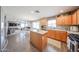 Spacious kitchen with an island, adjacent to dining and living areas at 12513 W Dreyfus Dr, El Mirage, AZ 85335