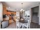 Cozy kitchen with wood cabinets, stainless steel appliances, and a round dining table at 12513 W Dreyfus Dr, El Mirage, AZ 85335