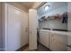 Functional laundry area with modern appliances and ample storage space, conveniently located near the garage at 12513 W Dreyfus Dr, El Mirage, AZ 85335
