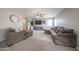 Comfortable living room with neutral tones, ceiling fan, and cozy seating arrangement at 12513 W Dreyfus Dr, El Mirage, AZ 85335