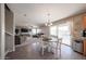 Open-concept living and dining area with a view of the backyard pool through sliding glass doors at 12513 W Dreyfus Dr, El Mirage, AZ 85335