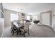 Open-concept living and dining area with neutral tones and abundant natural light at 12513 W Dreyfus Dr, El Mirage, AZ 85335