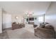 Spacious living room with plush sectional sofa, ceiling fan, and decorative wall accents at 12513 W Dreyfus Dr, El Mirage, AZ 85335