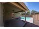 Covered patio leading to a backyard with pool views and desert landscape at 12845 W Milton Dr, Peoria, AZ 85383
