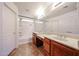 Bright bathroom with dual sinks, neutral tile, and a tub-shower combo at 12845 W Milton Dr, Peoria, AZ 85383