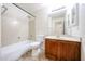 Bright bathroom with a vanity, a toilet, and a shower-tub combination, accented by neutral walls and tile flooring at 12845 W Milton Dr, Peoria, AZ 85383