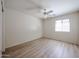 Light and airy bedroom featuring wood floors, a ceiling fan, and window at 12845 W Milton Dr, Peoria, AZ 85383