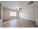 Large, bright bedroom showcasing neutral paint, stylish flooring, and a ceiling fan for added comfort at 12845 W Milton Dr, Peoria, AZ 85383