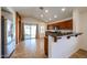 Open kitchen with stainless steel appliances, breakfast bar, and sliding glass doors at 12845 W Milton Dr, Peoria, AZ 85383