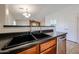 Close-up of the kitchen sink area, showcasing modern fixtures and a black countertop at 12845 W Milton Dr, Peoria, AZ 85383