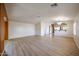 Open-concept living space with wood floors and modern lighting at 12845 W Milton Dr, Peoria, AZ 85383