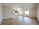 Spacious open-concept living area featuring wood floors and natural light from shuttered windows at 12845 W Milton Dr, Peoria, AZ 85383