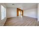 Bright living room with vaulted ceilings, wood-look floors, and large windows at 12845 W Milton Dr, Peoria, AZ 85383