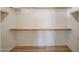 Spacious, empty walk-in closet with built-in shelving and a wood floor at 12845 W Milton Dr, Peoria, AZ 85383