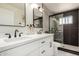 Modern bathroom featuring a double vanity, sleek black fixtures, and a glass-enclosed shower with tiled walls at 1539 W 5Th St, Tempe, AZ 85281