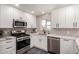 Close up of kitchen features stainless appliances, counter tops, and backsplash at 1539 W 5Th St, Tempe, AZ 85281